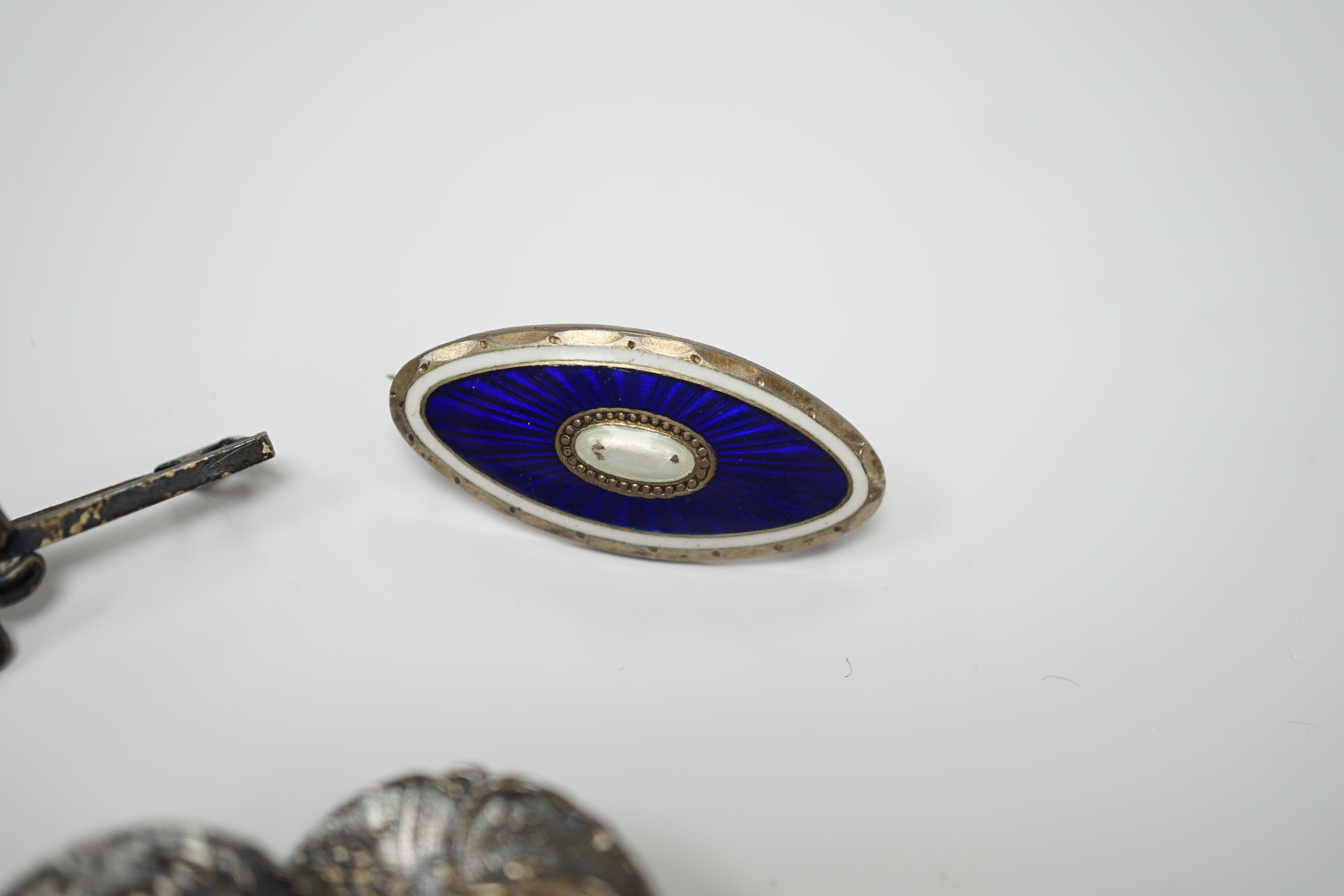 A Norwegian 925S and two colour enamel oval brooch, 28mm, a sterling and three colour enamel butterfly brooch, a white metal (stamped silver) and enamel swallow brooch, a pair of Edwardian Art Nouveau silver buttons and